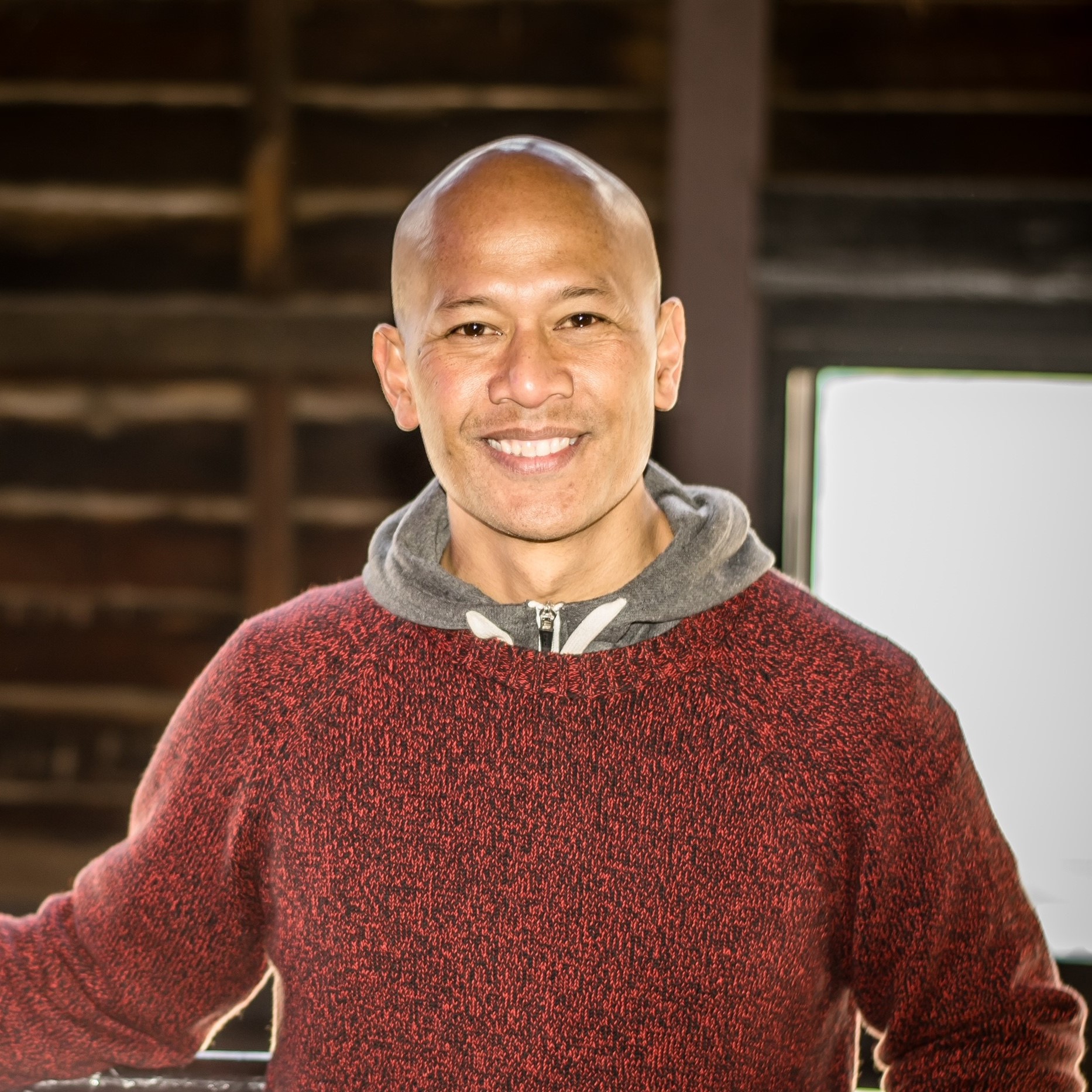 Man smiling in brown jumper